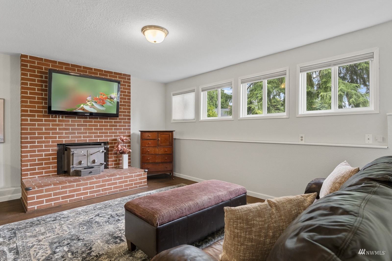 9651 Northeast 201st Street Bothell, WA 98011 - Photo 28 of 39 a living room with furniture or fireplace and a flat screen tv