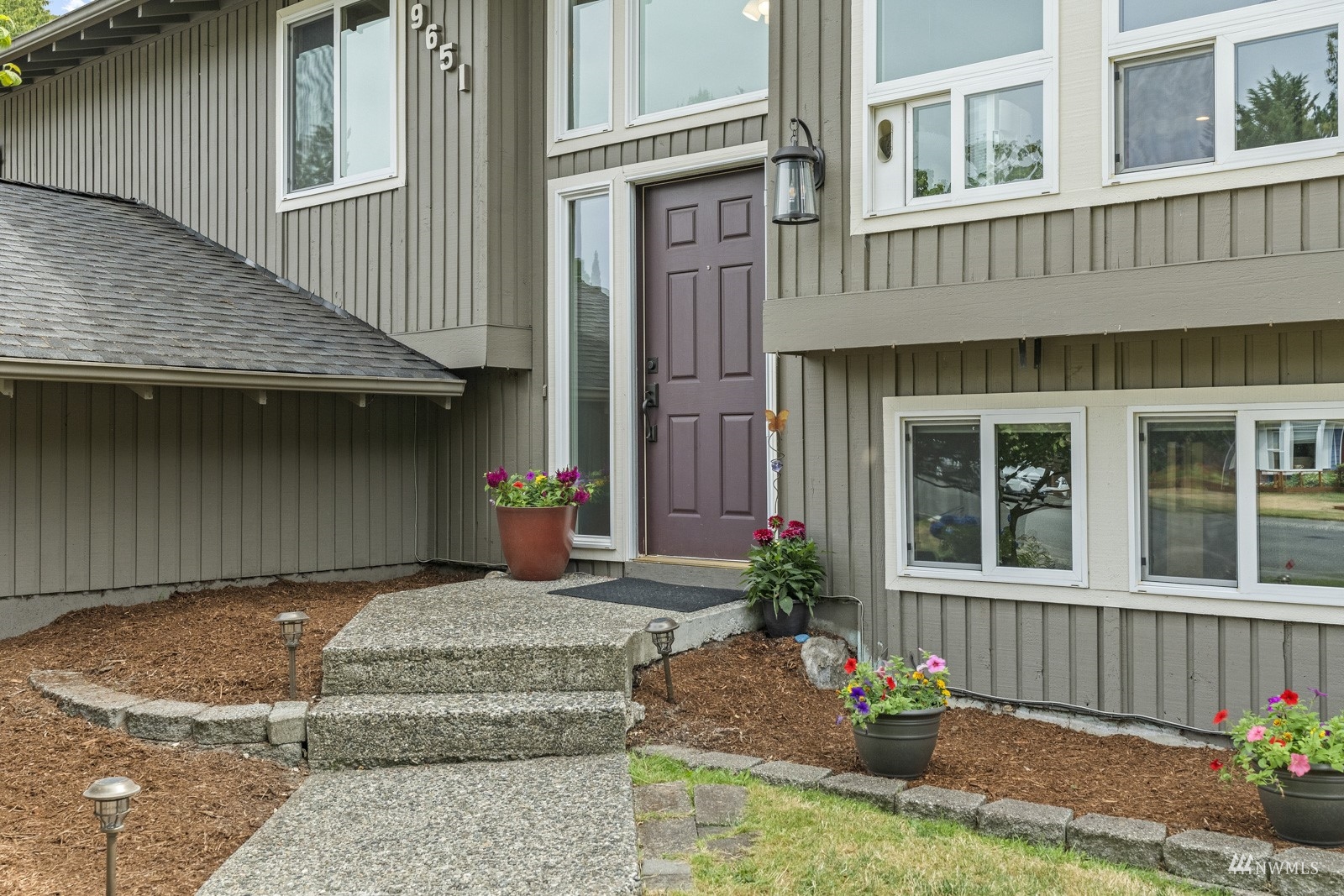 9651 Northeast 201st Street Bothell, WA 98011 - Photo 4 of 39 a front view of a house with a yard