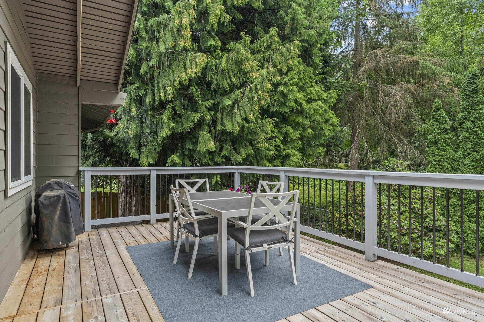 9651 Northeast 201st Street Bothell, WA 98011 - Photo 9 of 39 a roof deck with table and chairs and wooden floor