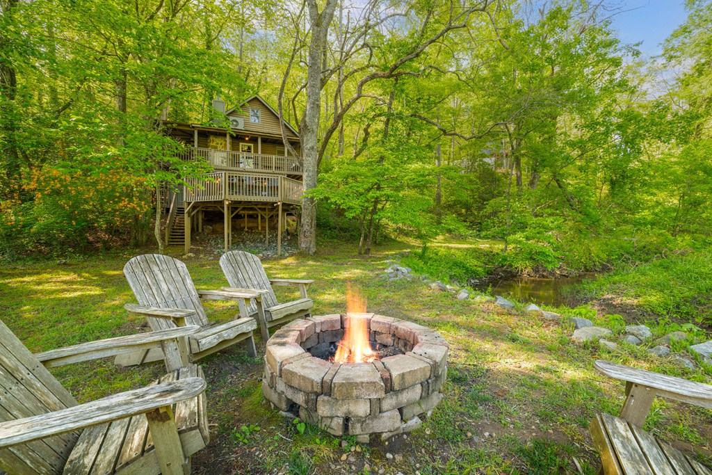 459 Mill Stone Mountain Lane Blue Ridge, GA 30513 - Photo 19 of 25 a backyard of a house with table and chairs