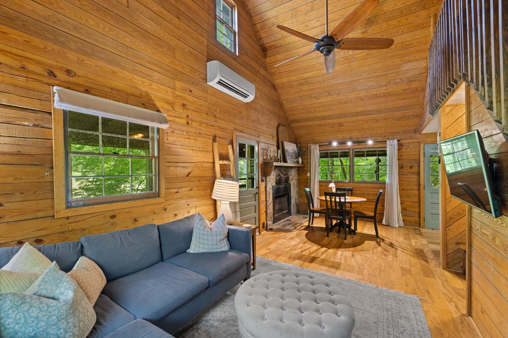 459 Mill Stone Mountain Lane Blue Ridge, GA 30513 - Photo 7 of 25 a living room with furniture a fireplace and a table