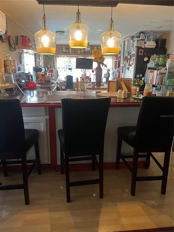 1005 Whitehurst Road, Unit 92 Plant City, FL 33563 - Photo 15 of 29 a kitchen with a dining table chairs and a chandelier