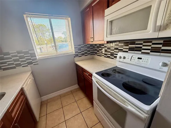a kitchen with a stove and a microwave