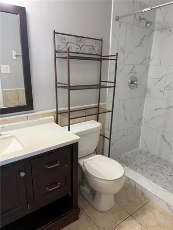 a bathroom with a toilet sink and shower