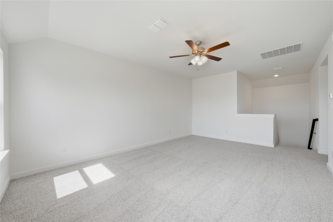 13501 Barn Chime Street Elgin, TX 78621 - Photo 13 of 19 an empty room with windows and fan