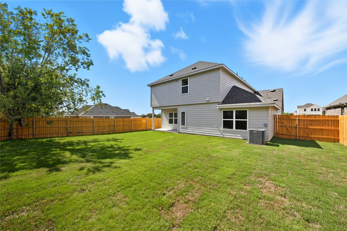 13501 Barn Chime Street Elgin, TX 78621 - Photo 16 of 19 a front view of a house with a yard