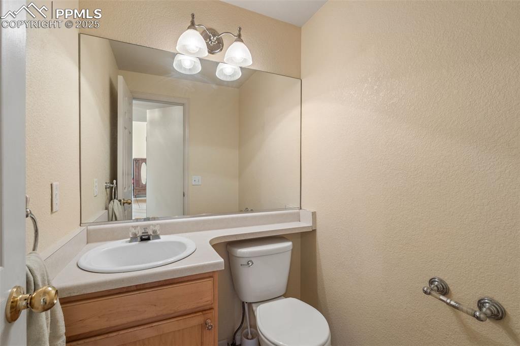 8654 Champie Road Peyton, CO 80831 - Photo 21 of 40 a bathroom with a toilet sink and mirror