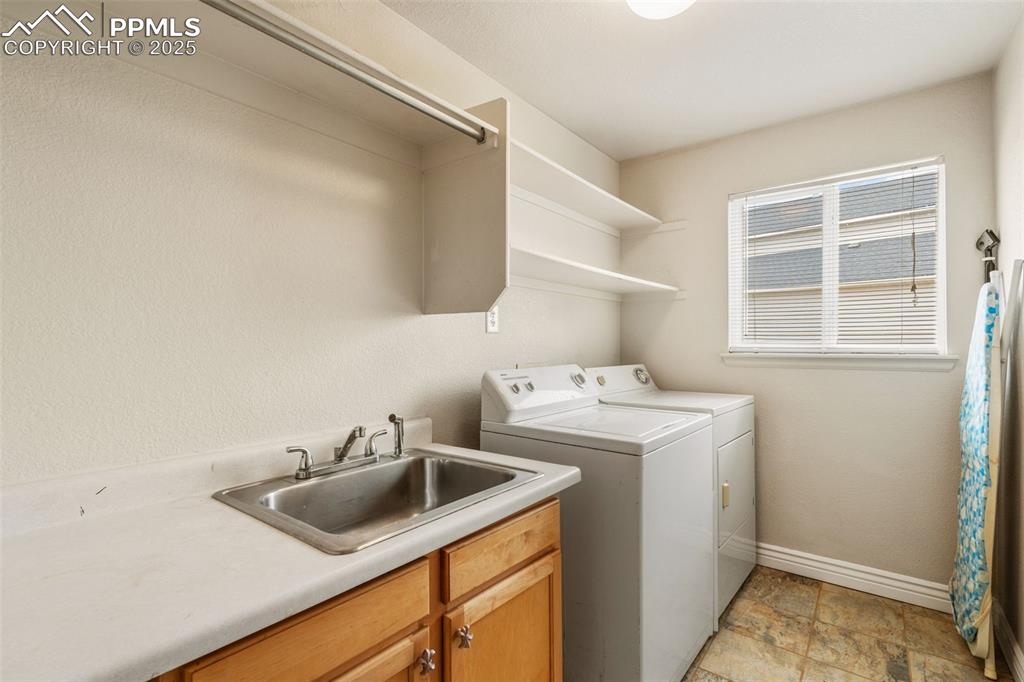8654 Champie Road Peyton, CO 80831 - Photo 22 of 40 a utility room with sink dryer and washer