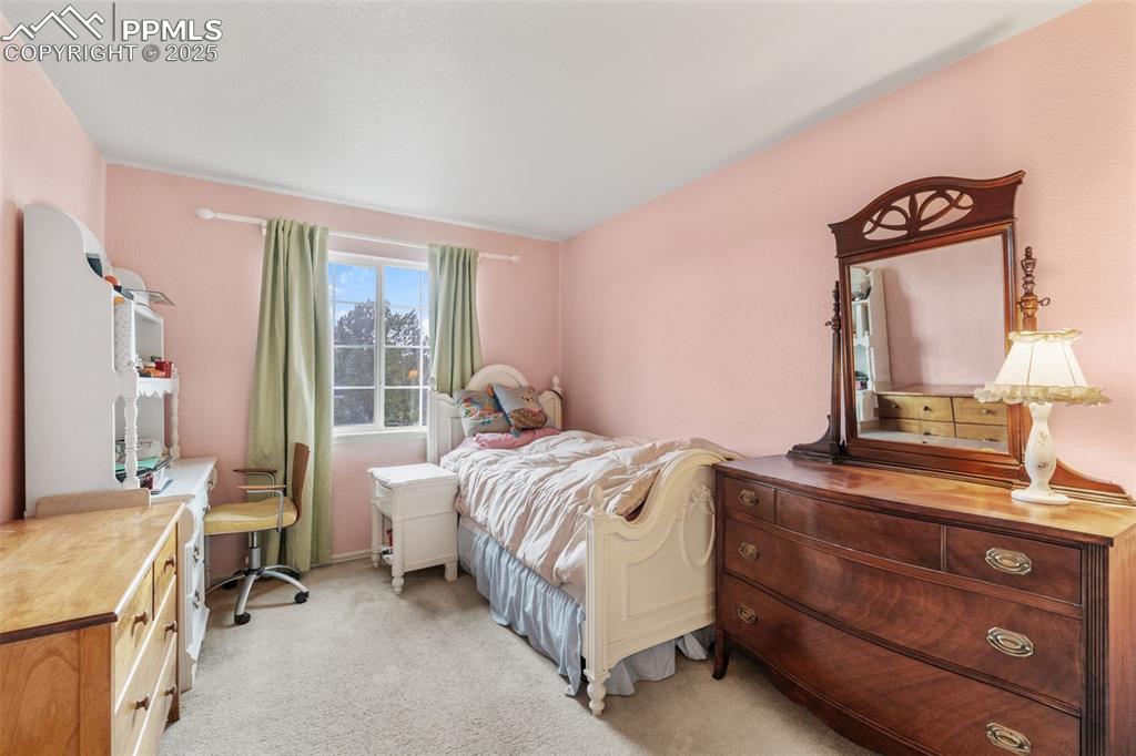 8654 Champie Road Peyton, CO 80831 - Photo 31 of 40 a bedroom with a bed and large windows