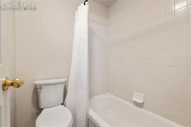 a white toilet sitting next to a white sink