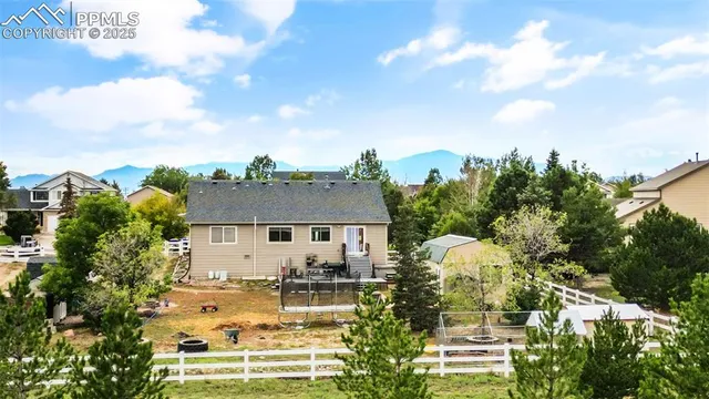 aerial view of a house with a yard and plants