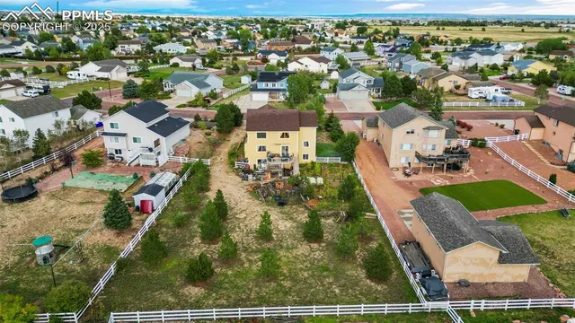 an aerial view of residential houses with outdoor space