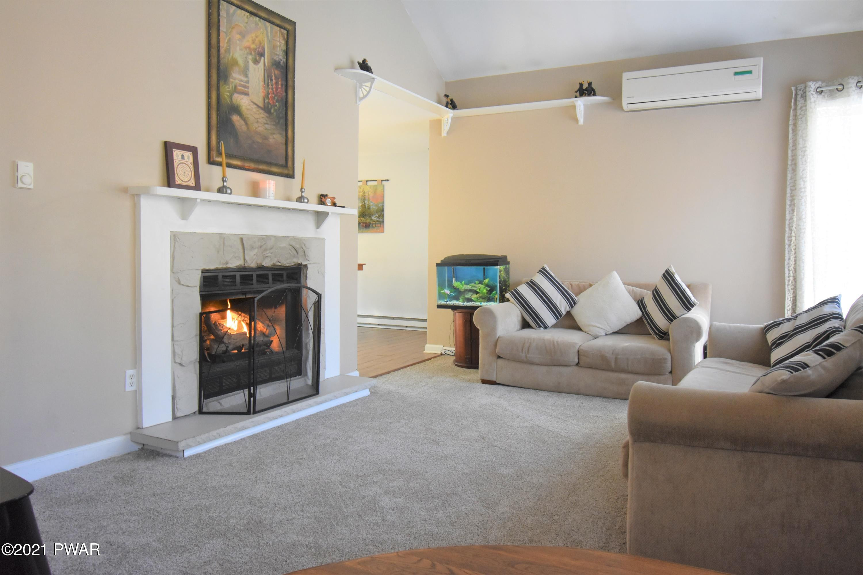 244 Fox Road Dingmans Ferry, PA 18328 - Photo 5 of 31 a living room with furniture and a fireplace