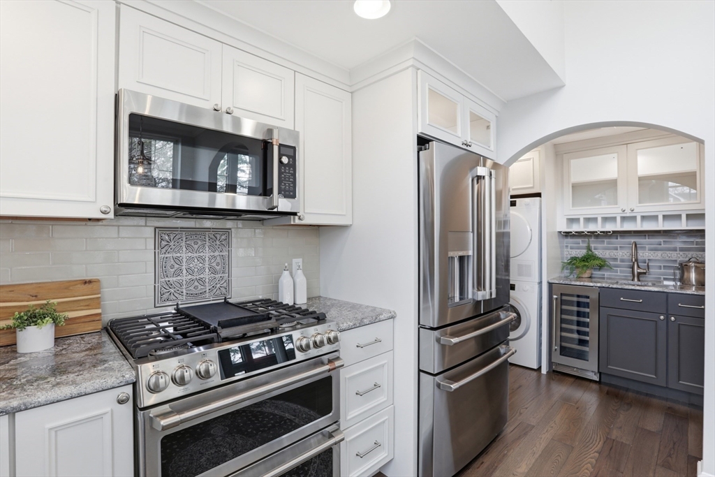 83 Church Street, Unit 15 Winchester, MA 01890 - Photo 14 of 34 a kitchen with stainless steel appliances granite countertop a stove a refrigerator and a microwave