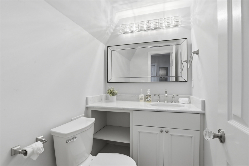 83 Church Street, Unit 15 Winchester, MA 01890 - Photo 18 of 34 a bathroom with a toilet a sink and mirror