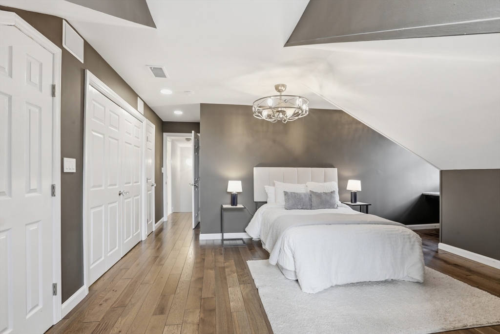 83 Church Street, Unit 15 Winchester, MA 01890 - Photo 21 of 34 a bedroom with a large bed and a chandelier