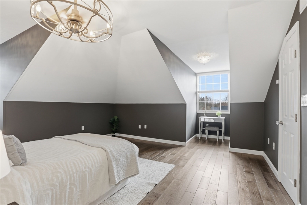 83 Church Street, Unit 15 Winchester, MA 01890 - Photo 22 of 34 a bedroom with a bed and a table in it