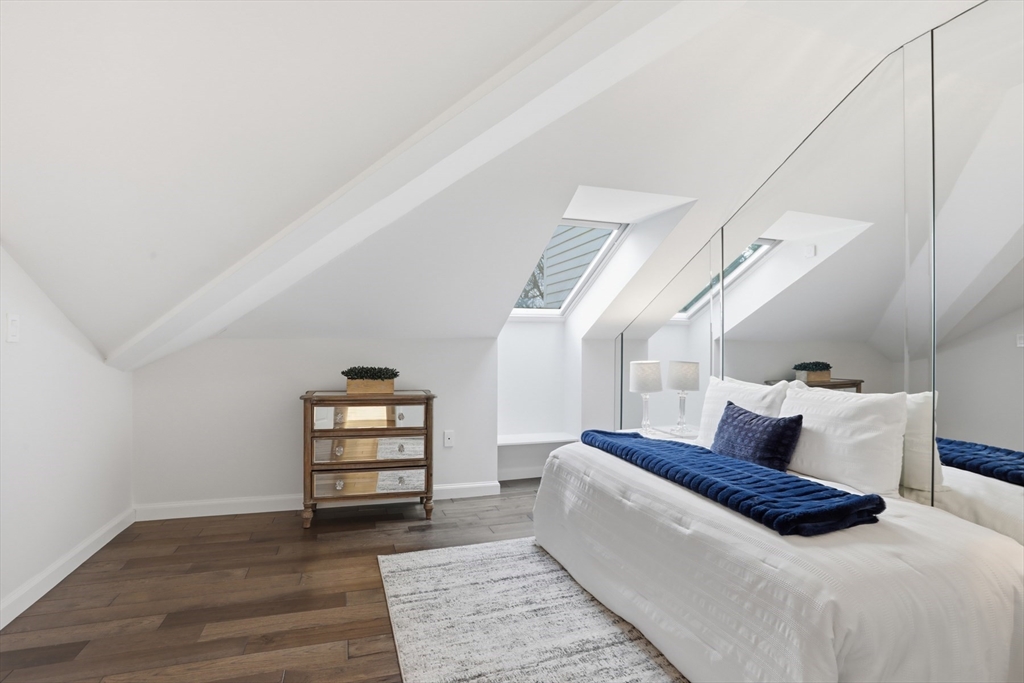 83 Church Street, Unit 15 Winchester, MA 01890 - Photo 23 of 34 a bedroom with a bed and wooden floor