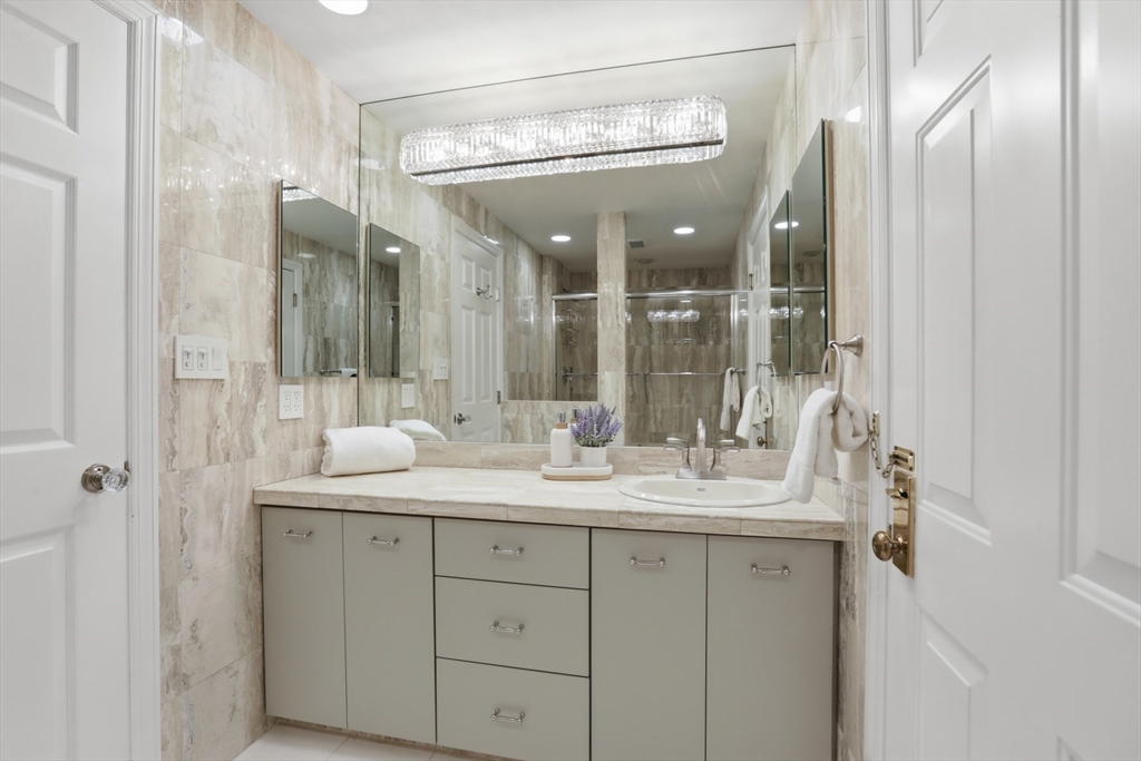 83 Church Street, Unit 15 Winchester, MA 01890 - Photo 25 of 34 a bathroom with a double vanity sink and mirror