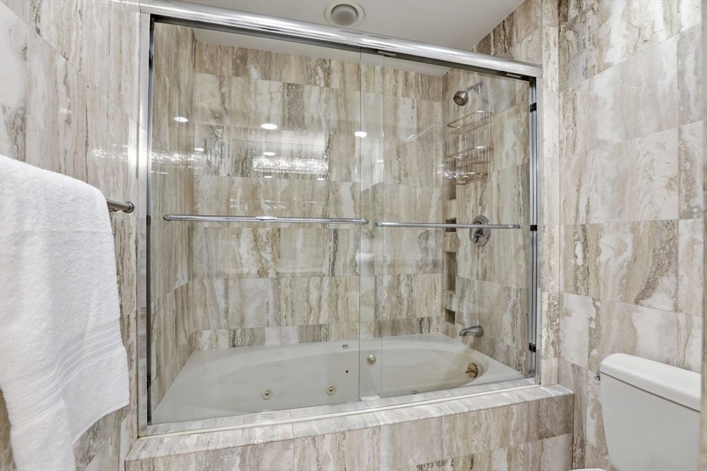 83 Church Street, Unit 15 Winchester, MA 01890 - Photo 27 of 34 a bathroom with a bathtub and a shower