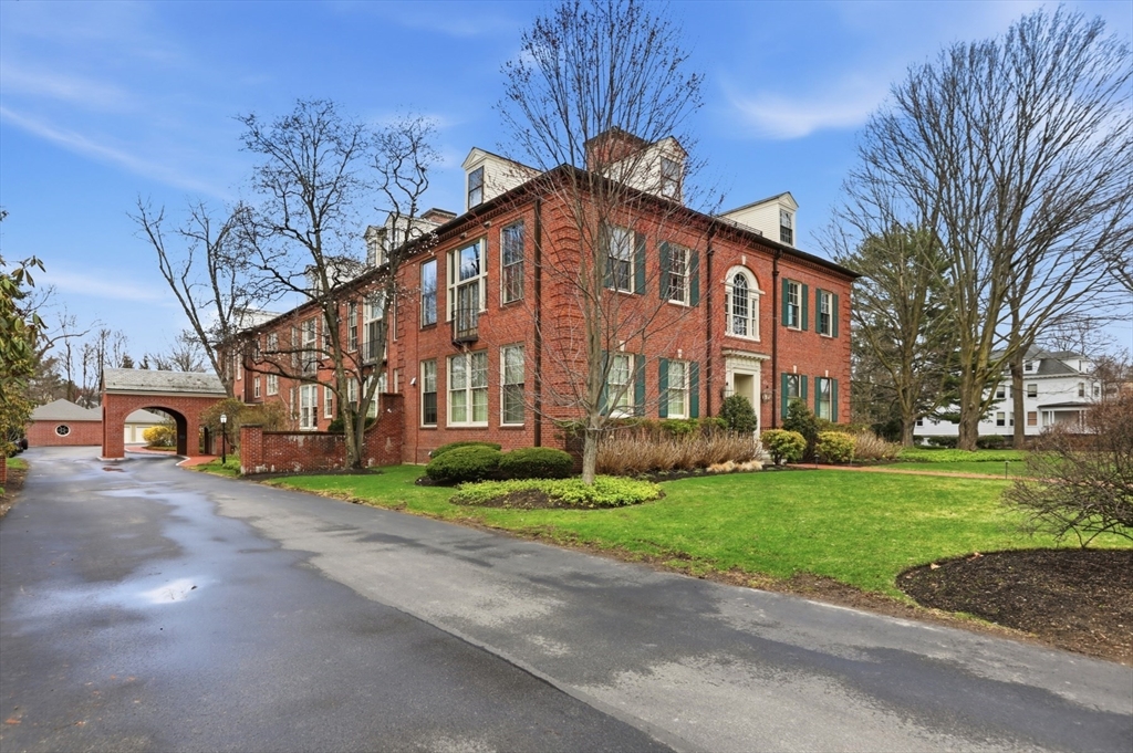83 Church Street, Unit 15 Winchester, MA 01890 - Photo 34 of 34 a front view of a building with a garden
