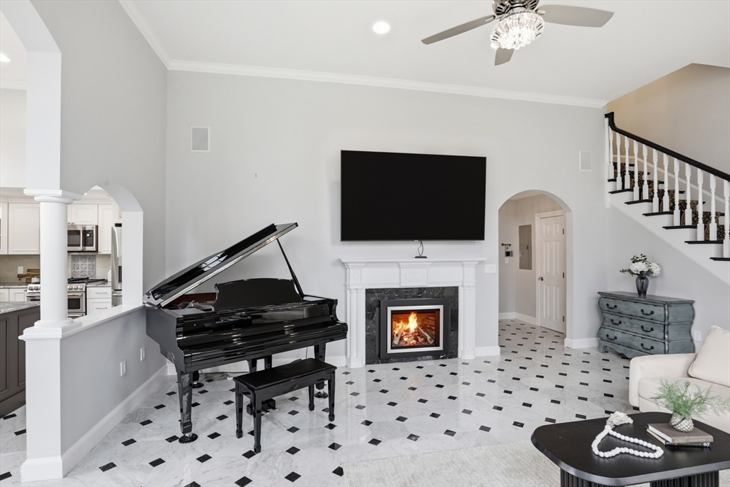 83 Church Street, Unit 15 Winchester, MA 01890 - Photo 4 of 34 a living room with furniture a fireplace and a flat screen tv