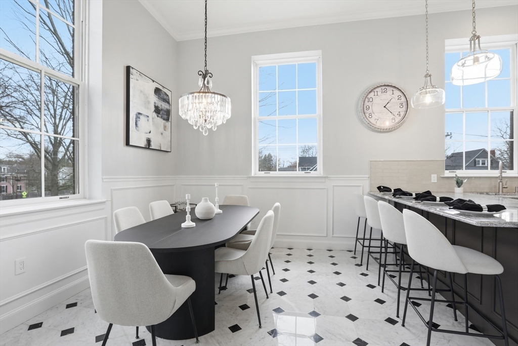 83 Church Street, Unit 15 Winchester, MA 01890 - Photo 8 of 34 a dining room with wooden floor a glass table and chairs