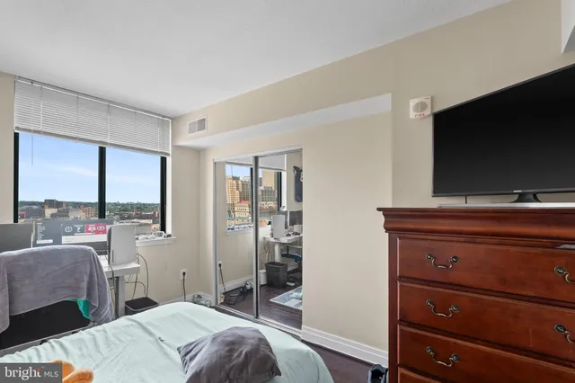 a bedroom with a bed and a flat screen tv