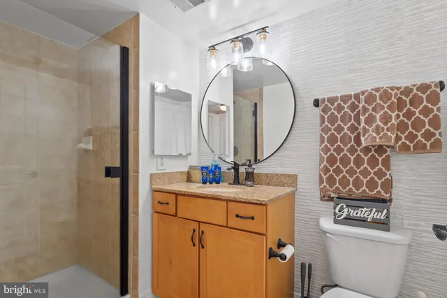 a bathroom with a sink mirror and toilet