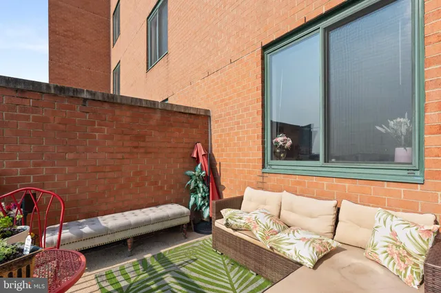 a view of a patio with couches and a potted plant