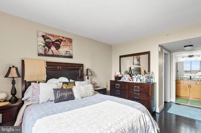 a bedroom with a bed and wooden floor