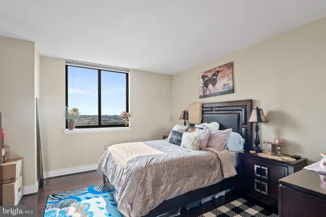 a bedroom with a bed and a painting on the wall