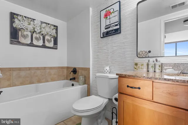 a bathroom with a toilet a sink and a bathtub