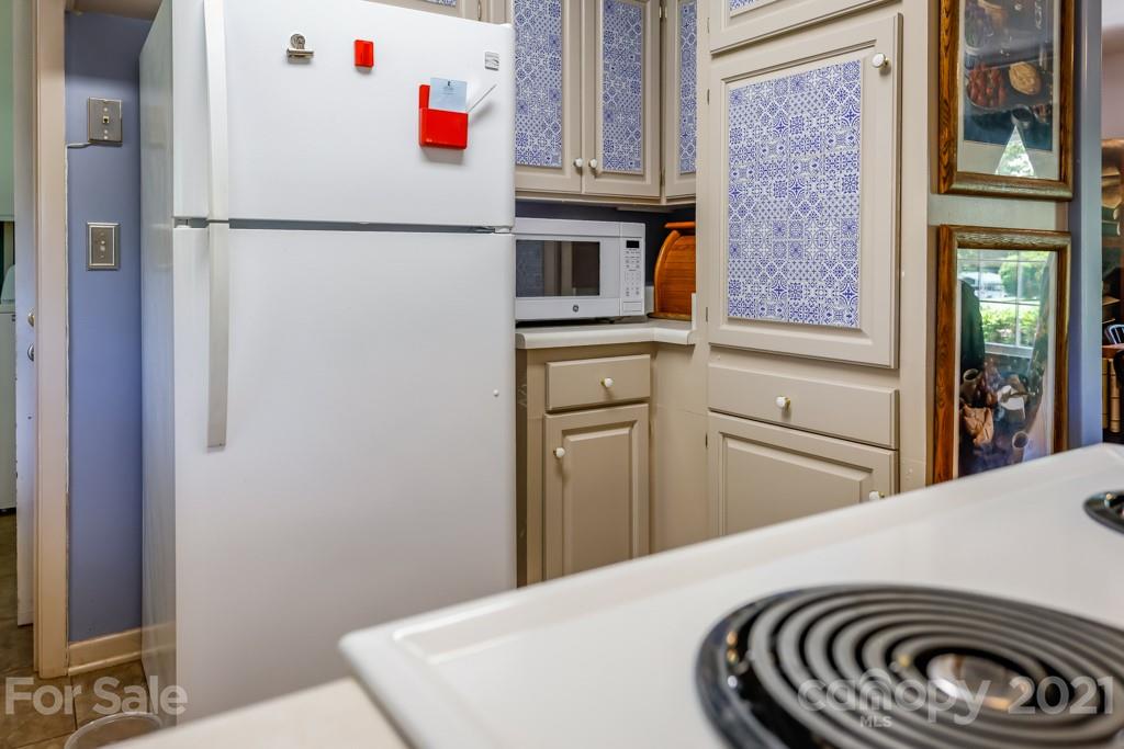 147 Ridgeland Drive Rutherfordton, NC 28139 - Photo 11 of 37 a kitchen with a white cabinets and white appliances