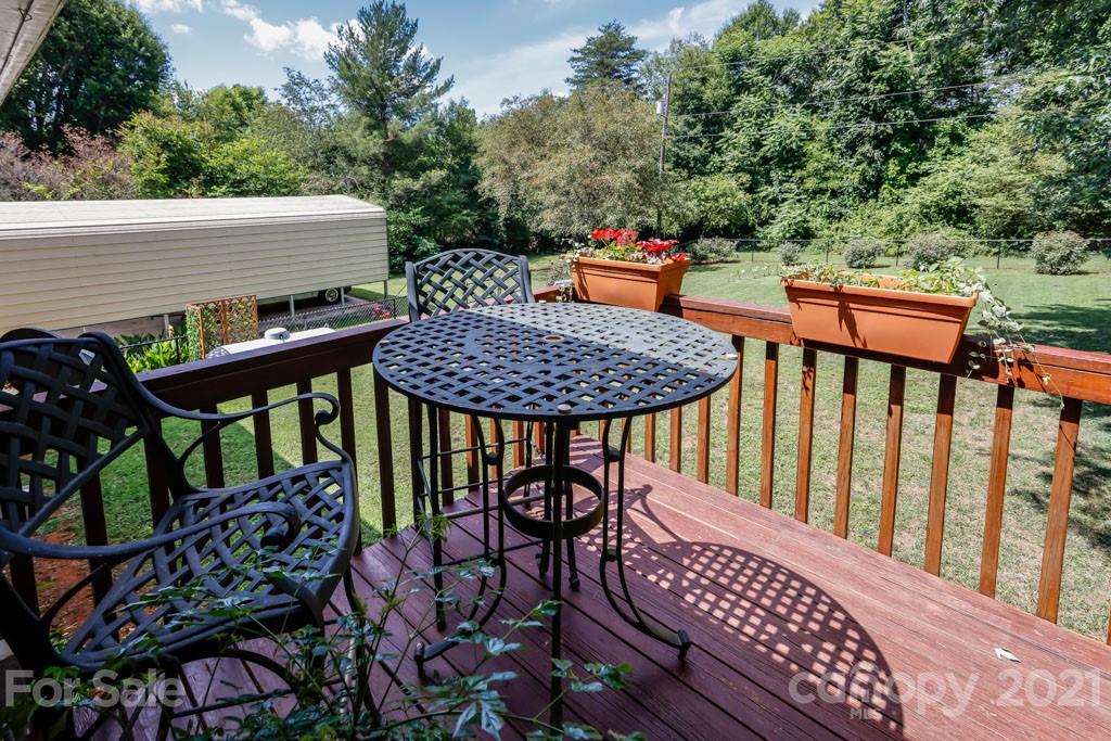 147 Ridgeland Drive Rutherfordton, NC 28139 - Photo 24 of 37 a roof deck with a dining table and chairs with wooden floor