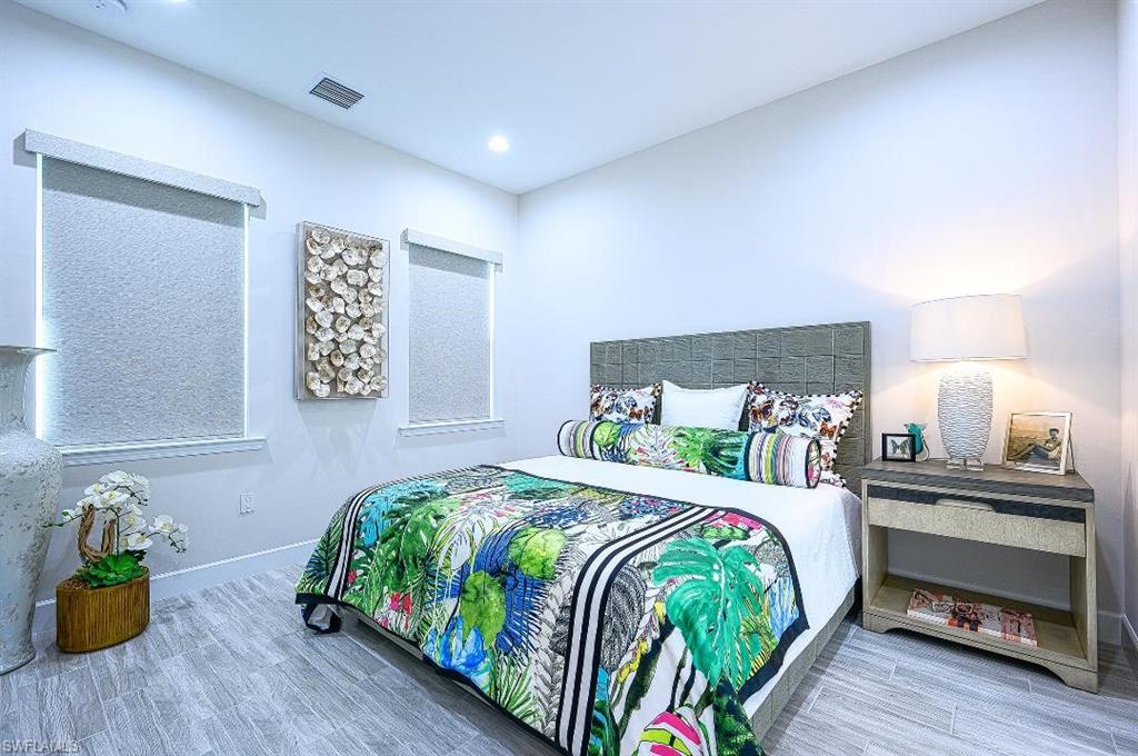 7164 Cayo Coco Lane Naples, FL 34113 - Photo 11 of 17 a bedroom with a bed and a table