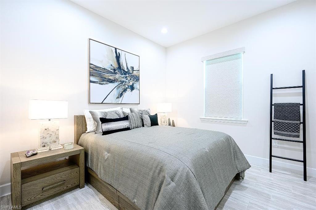 7164 Cayo Coco Lane Naples, FL 34113 - Photo 13 of 17 a bedroom with a bed and a window