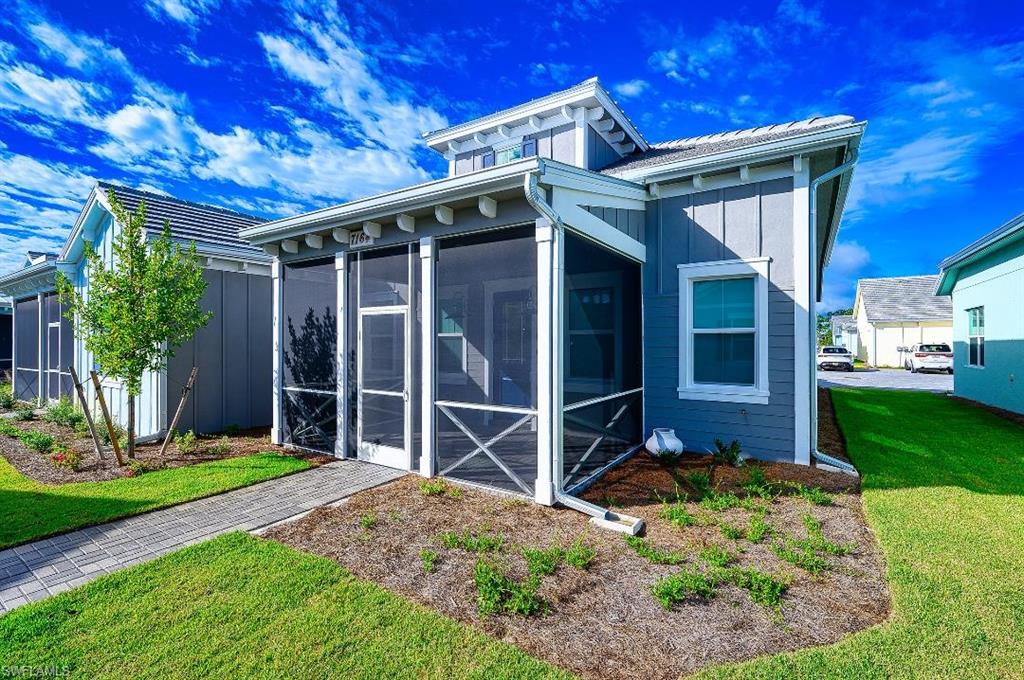 7164 Cayo Coco Lane Naples, FL 34113 - Photo 3 of 17 a backyard of a house with lots of green space and potted plants