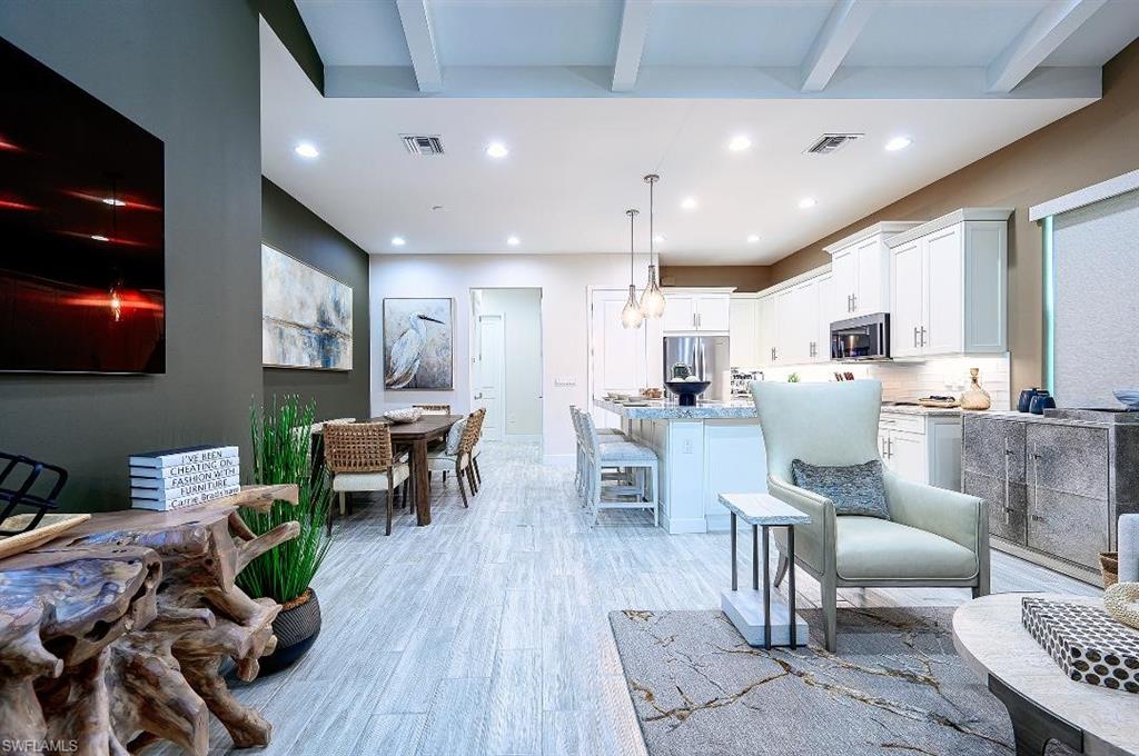 7164 Cayo Coco Lane Naples, FL 34113 - Photo 4 of 17 a living room with lots of furniture kitchen view and a wooden floor