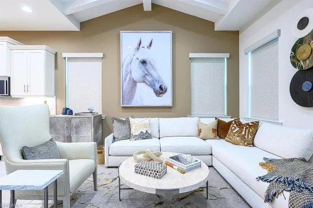 a living room with a couch and a painting on the wall