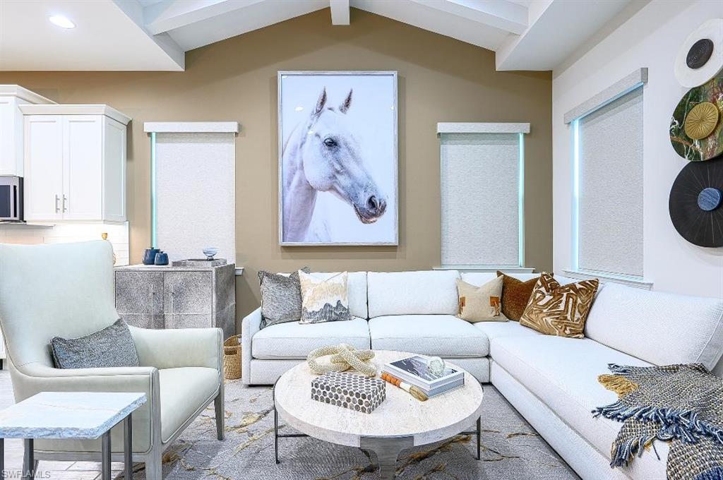 7164 Cayo Coco Lane Naples, FL 34113 - Photo 6 of 17 a living room with a couch and a painting on the wall