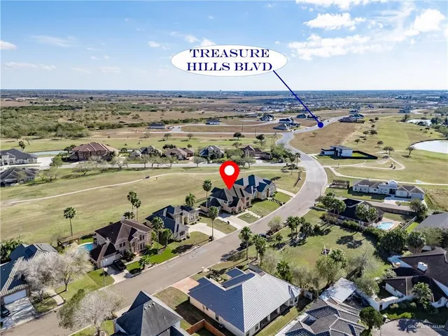 a kitchen with granite countertop a sink a stove top oven a dining table and chairs