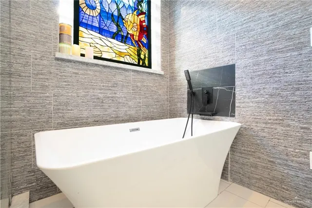 a bathroom with a granite countertop sink a mirror and shower