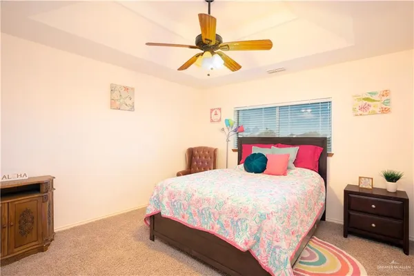 a bedroom with a bed a table and book shelf