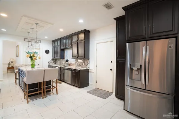 a bathroom with a granite countertop sink a toilet and shower