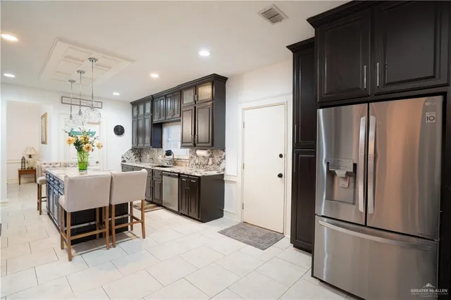 a bathroom with a granite countertop sink a toilet and shower