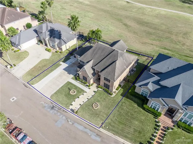 an aerial view of a house with a yard