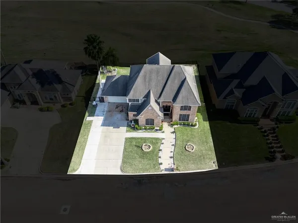 an aerial view of a house with outdoor space swimming pool and ocean view