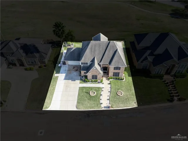 an aerial view of a house with outdoor space swimming pool and ocean view