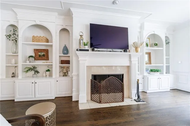 a open kitchen with stainless steel appliances granite countertop a sink dishwasher a stove a dining table with chairs and wooden floor